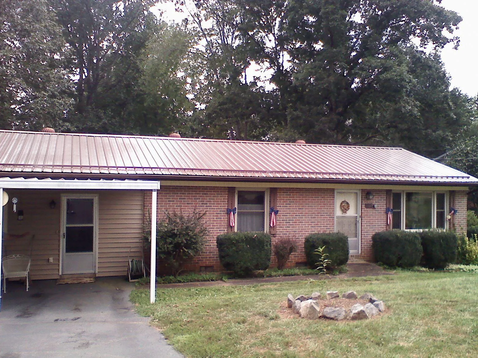 Bronze metal roof and carport on a brick ranch home — Roof Repair work by our crew in West Alexandria