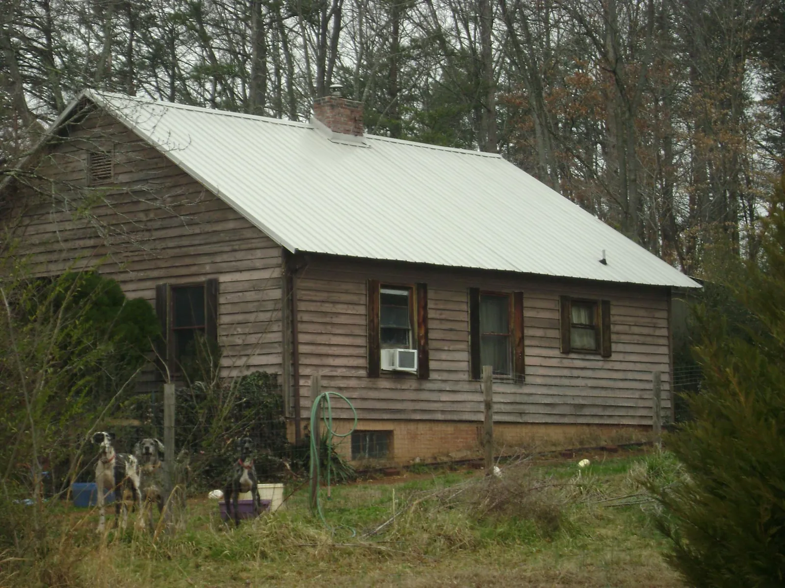 White metal roof on an old wood sided farmhouse, from a Metal Roof Installation job in West Alexandria